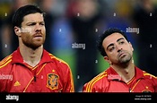 Spain's Xabi Alonso (l) and Xavi Hernandez listen to the national ...