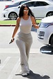 Kim Kardashian dons a form-fitting all grey ensemble as she arrives at ...