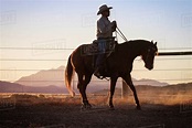 Man horseback riding at sunset - Stock Photo - Dissolve