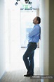 Mature man leaning against wall in corridor — male, time - Stock Photo ...