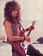 a man with long hair is holding a guitar and posing for a magazine cover photo