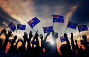 Group of People Waving Australian Flags in Back Lit - Littlegate Publishing