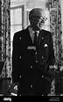 Milton Stover Eisenhower, Portrait photograph, Standing, Knees up ...