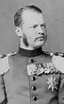 an old black and white photo of a man in uniform