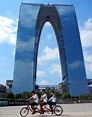 Bicycle ride past the pants-shaped skyscraper, Gate of the Orient, in ...