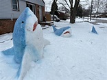 Michigan woman creates snow sharks on her front lawn. - mlive.com