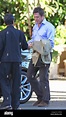 Hugh Grant wearing brown suede shoes leaves a hotel and gets into a ...
