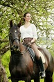 Woman horseback riding - Stock Photo - Dissolve