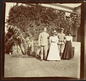Adelbert S. Hay standing in garden with friends (two women and a ...
