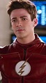 the flash standing in front of a tv screen with his hand on his hip and ...