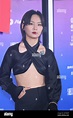 Chinese singer Zhou Bichang, wears a black short top, attends the ...