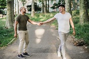 Two Men Holding Hands and Walking Together · Free Stock Photo