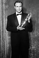 “Marlon Brando holding his Oscar after winning Best Actor at the 27th ...