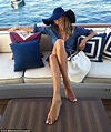 Elle MacPherson shows off her toned tummy and impossibly long legs ...