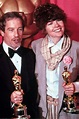 two people posing with their oscars