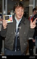 Paul McCartney holds up the new album from his band 'The Fireman' as ...