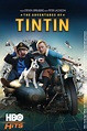 the dvd cover for tintin, featuring two men and a dog in front of them