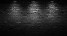 El fondo de la pared de ladrillo negro y la luz de la lámpara. | Foto ...