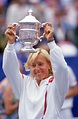 Martina Navratilova hoists her trophy as she celebrates winning the ...