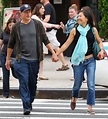 Woody Harrelson grins as he walks hand in hand with his wife Laura ...