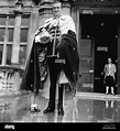 The Marquess of Bath dressed in full ceremonial robes uses his cape to ...