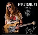 a man with long hair and sunglasses playing an electric guitar in front ...
