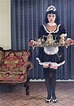 Maid serving tea in ornate living room - Stock Photo - Dissolve