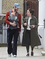 Howard Donald and wife Katie Halil stop to take a photo with their son ...