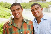 Hispanic twin brothers hugging - Stock Photo - Dissolve