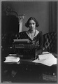 [Flora Payne Whitney Miller, three-quarter length portrait, seated at typewriter, facing front ...