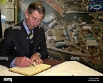 The Prince of Wales signs the visitors' book at the Royal National ...