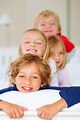 Smiling Brothers and Sisters Having Fun Together in Bed. Portrait of ...