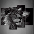 a black and white photo of a lion's face on a wall in a room