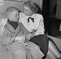 Christopher Crawford sitting beside her mother, Joan Crawford