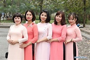 Vietnamese women wearing traditional costume Ao Dai pose for photos in ...