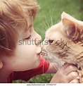 Young boy kissing his cat