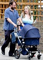 David Mitchell pushes his baby daughter Barbara in her pram with wife ...
