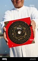 Feng Shui master holding a Compass Stock Photo - Alamy