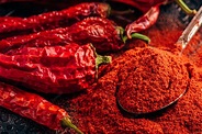 Premium Photo | Spoonful of ground red chili pepper