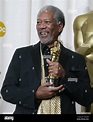 Morgan Freeman holds his award after winning the best supporting actor ...