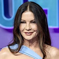 Catherine Zeta-Jones shows off her curves in a deep blue dress for the ...