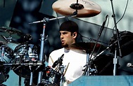a man is playing drums on stage