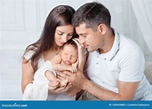 Woman and Man Holding a Newborn. Mom, Dad and Baby. Close-up. Portrait ...