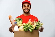 Delivery Concept – Handsome African American delivery man carrying ...