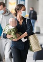 Alicia Vikander cradles a baby while at an airport with husband Michael ...