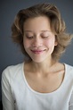 Portrait of smiling beautiful woman happily looking down | Sandie Byrne