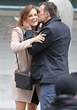 Riley Keough smiles as co-star Shaun Benson kisses her on the set of ...