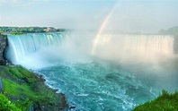 A beautiful rainbow forms over the edge of Horseshoe Falls, in Niagara ...
