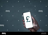 Smartphone screen showing a British pound symbol Stock Photo - Alamy
