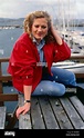 Tracey Childs sitting on wooden table November 1988 Stock Photo - Alamy